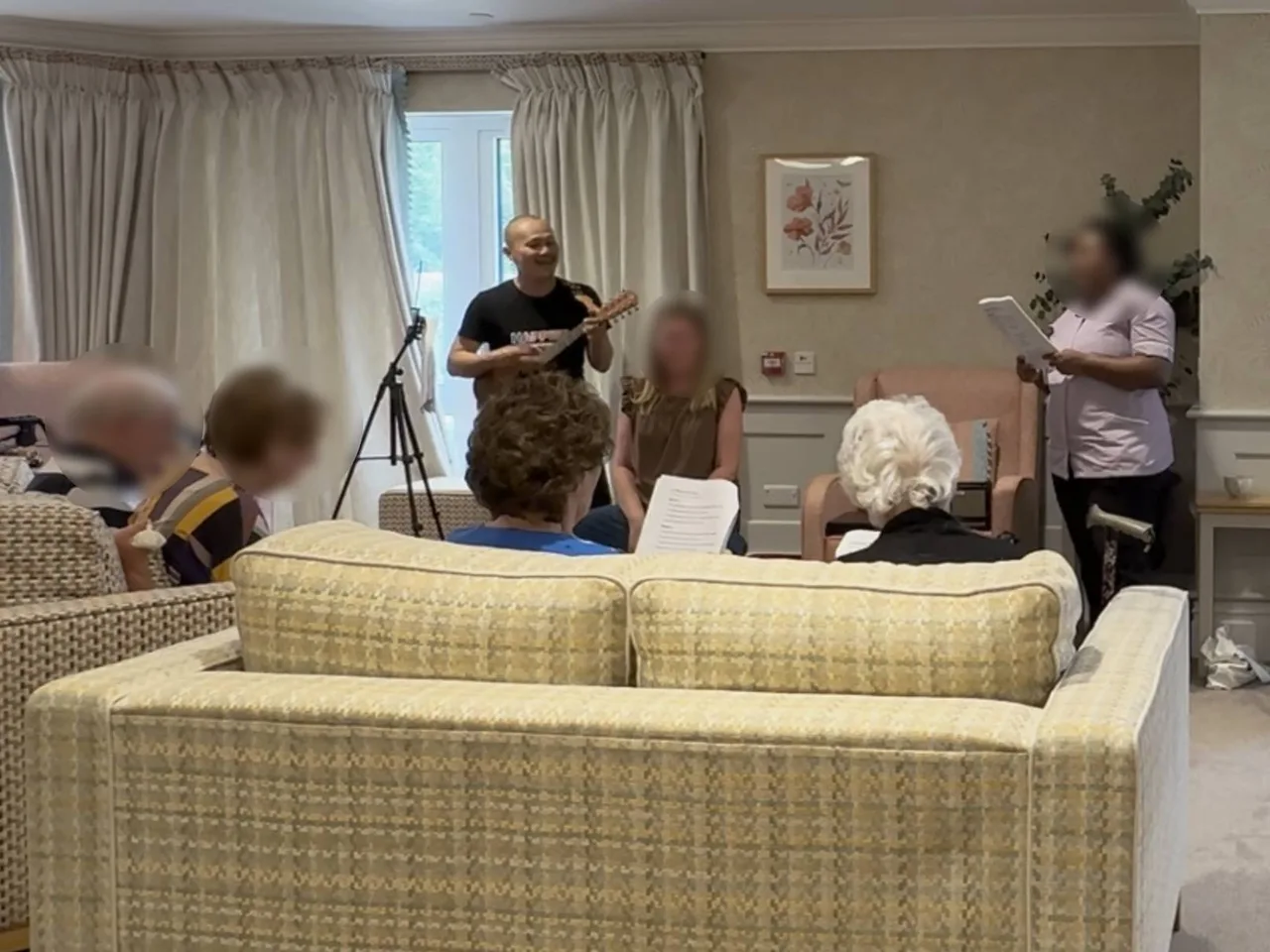 Frven leading a ukulele sing-along with care home residents and staff — HappierMusic life enrichment session, North London and Hertfordshire